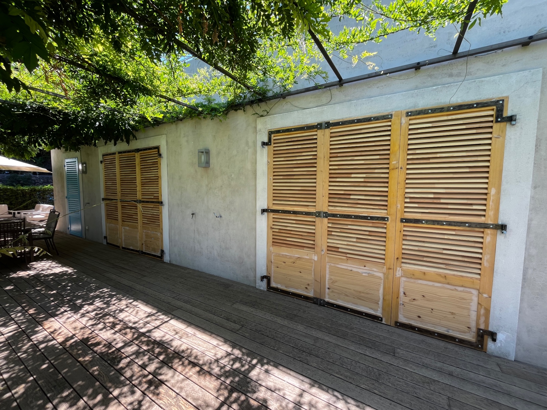 LUX RENOV — volets bois bruts installés en double façade sur la terrasse avant teinte