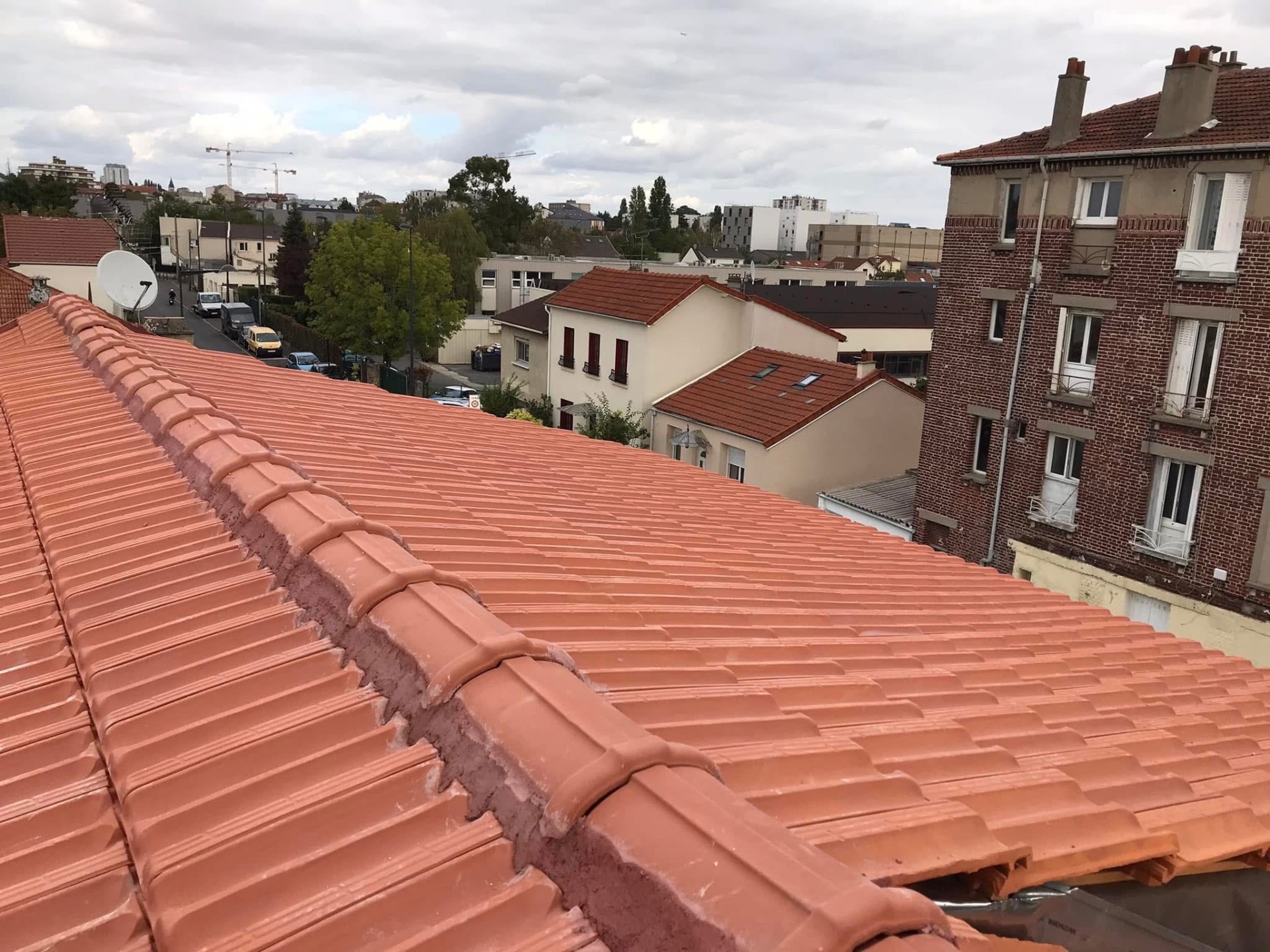 LUX RENOV — toiture finie avec faîtière scellée et vue sur le quartier