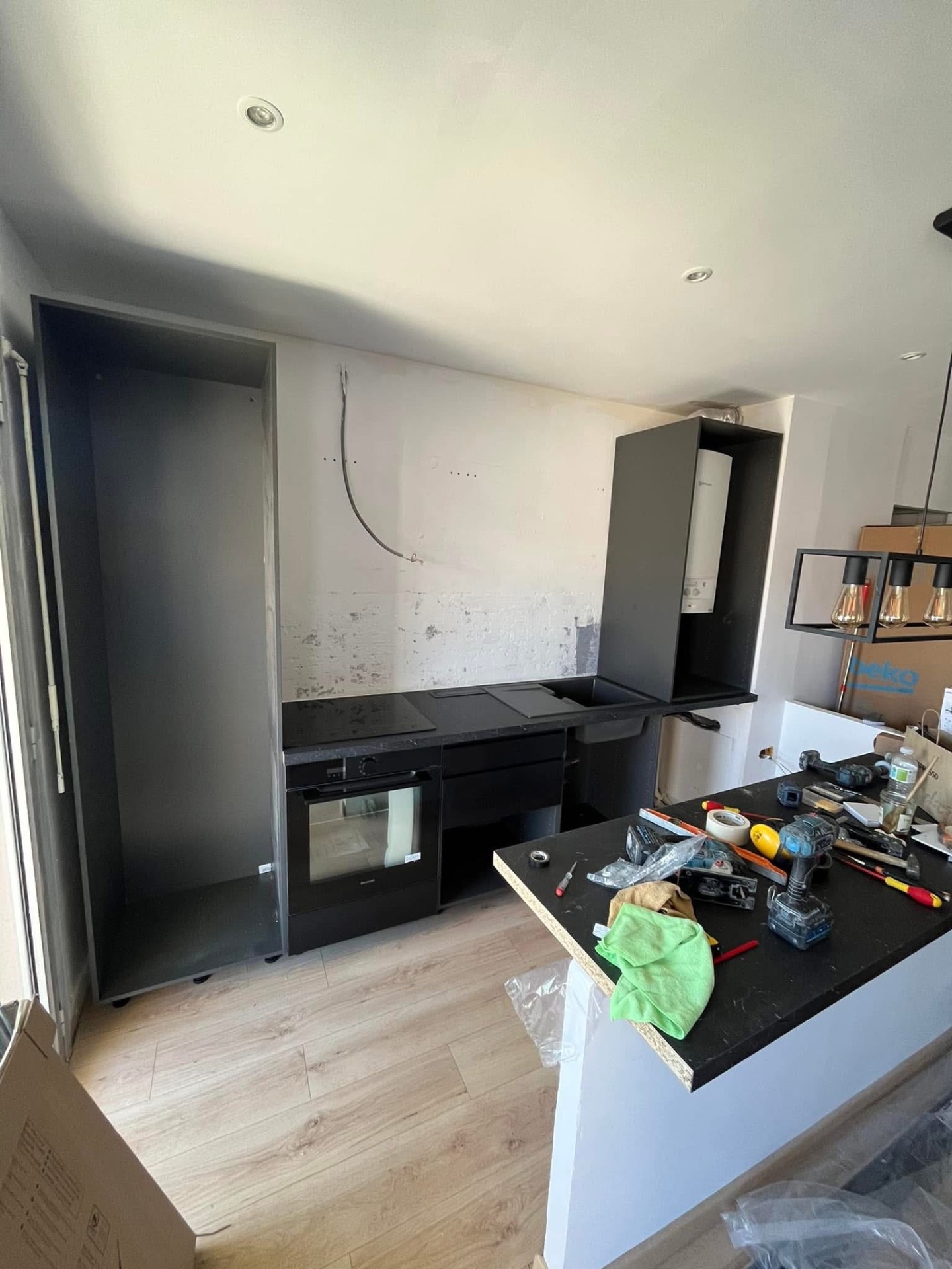 LUX RENOV — pose des meubles noirs et plan de travail granit en cours