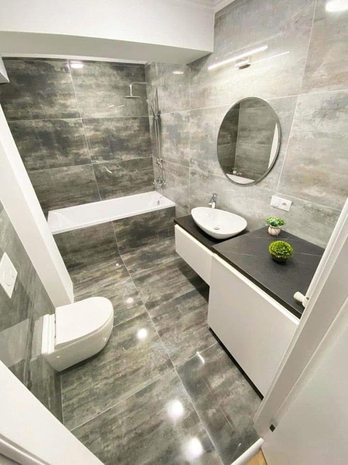 LUX RENOV — salle de bain effet béton avec baignoire et miroir rond